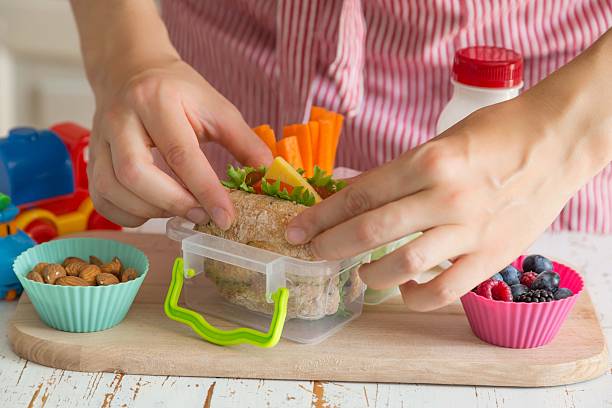 istock Mother making school lunch in the kitchen 587921600