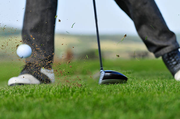 istock Golf ball and golf club in green grass 587928442