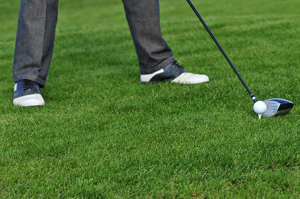 istock Golf ball and golf club in green grass 587928444