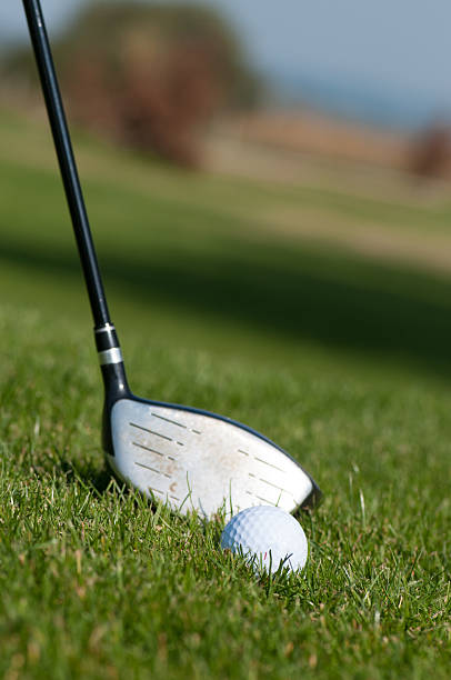 istock Golf ball and golf club in green grass 587928462