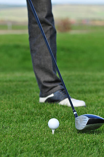istock Golf ball and golf club in green grass 587928474