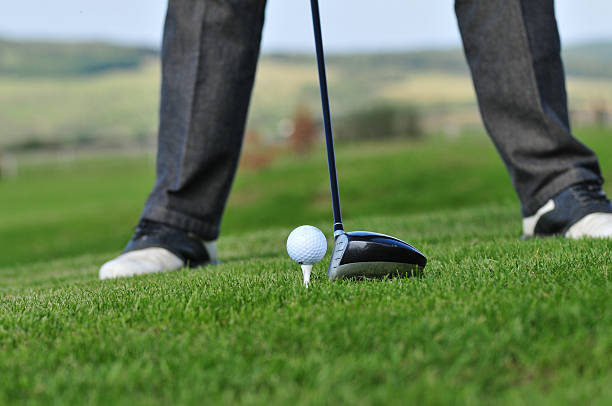 istock Golf ball and golf club in green grass 587928476