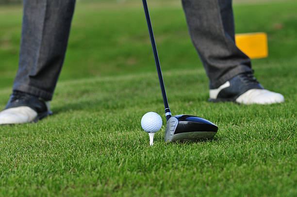 istock Golf ball and golf club in green grass 587928486