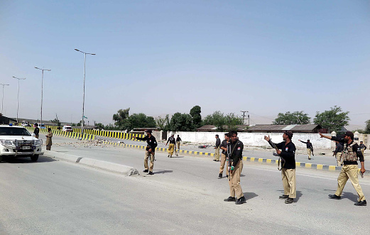 Quetta, Pakistan - August 11, 2016: Security officials cordon off venue after a remote-controlled bomb blast to investigate and for collection of evidence, at Zarghoon road in Quetta. At least 13 people including a policeman were injured in a remote-controlled bomb blast near on Zarghoon Road. Balochistan Federal Shariat Court Judge Zahoor Shawani was the target in the attack. His Anti Terrorism Force was damaged during the incident.