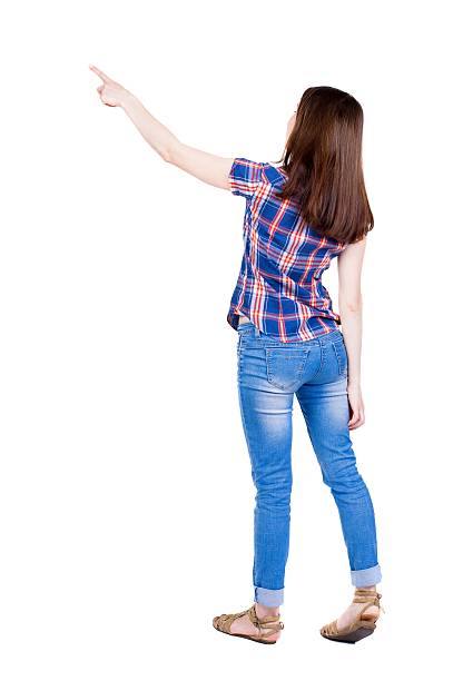 istock Back view of  pointing woman. 587930868