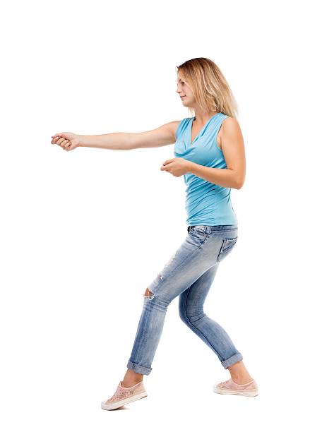 istock back view of standing girl pulling a rope from the 587930976