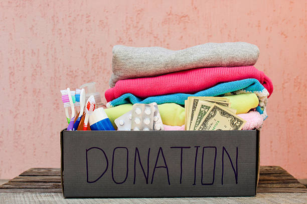 istock Donation box with clothes, living essentials and money 587931292