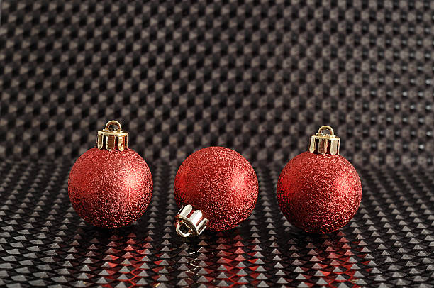 istock Red Christmas tree baubles isolated on a black background 587931778