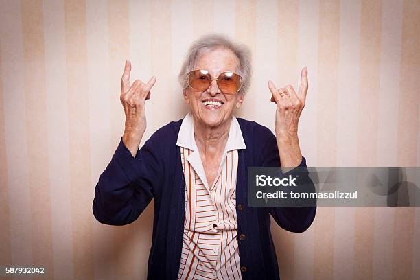 Cool Elder Lady Making Rock On Sign Stock Photo - Download Image Now - Bizarre, Women, Senior Adult