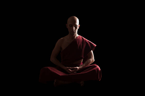 istock buddhist monk in meditation pose over black background 587932524