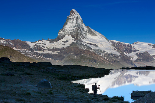 Nature photographer with tent at Matterhorn in Switzerland