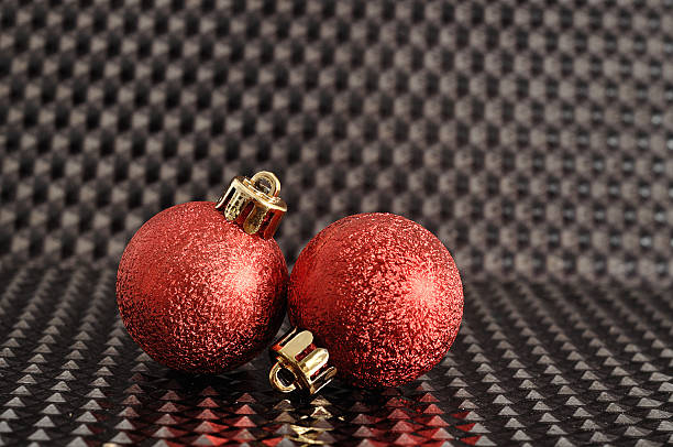istock Red Christmas tree baubles isolated on a black background 587933008