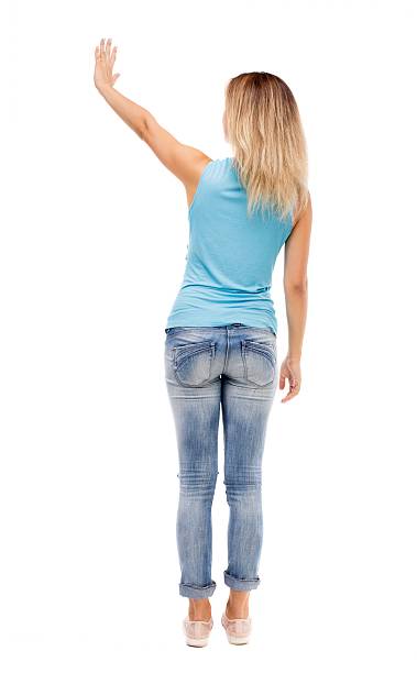 istock Back view of beautiful woman welcomes. 587933688