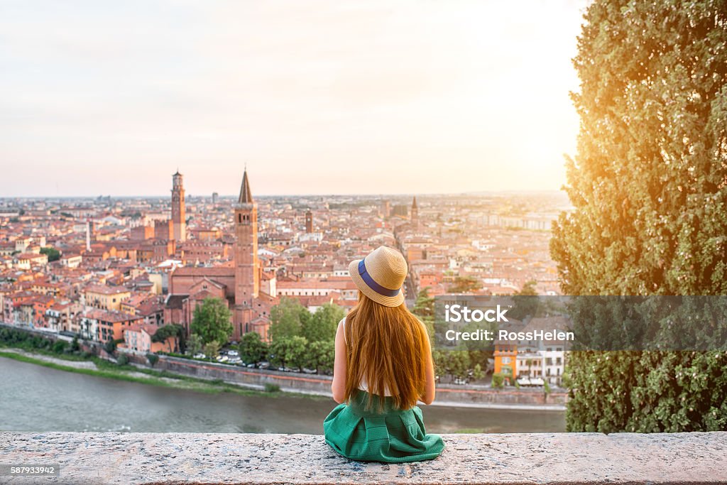 Woman enjoying beautiful view on Verona city Woman enjoying beautiful view on Verona city in Italy on the sunset. Verona is famous city of love in the north of Italy. Italy Stock Photo