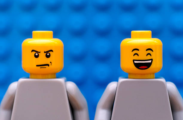 Two Lego minifigures - strict and happy stock photo