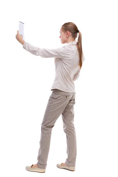 istock back view of  stands woman takes notes in a notebook 587934960