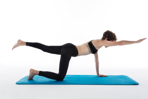 istock woman showing different pilates exercises 587935330