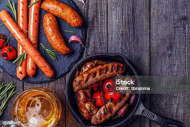 Grilled Sausages With Glass Of Beer On Wooden Table Stock Photo - Download Image Now