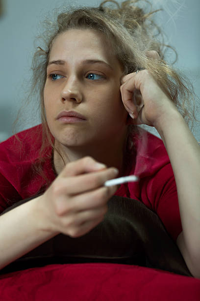 istock Rebellious teenager smoking cigarette 587936742