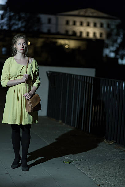 istock Lonely girl walking at night 587937322