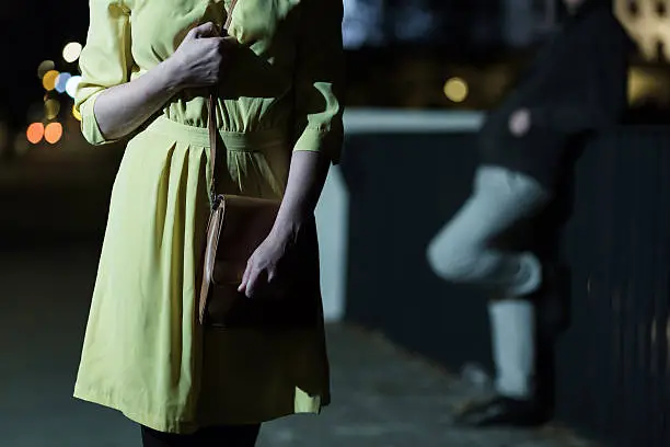 Young afraid woman walking alone at night