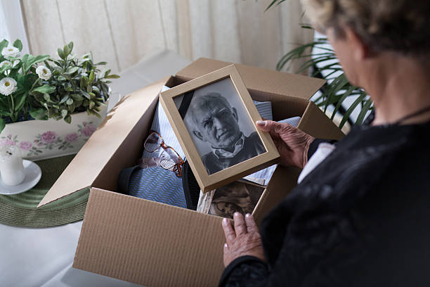 Last look on husband Woman is packing things of her dead husband loss photos stock pictures, royalty-free photos & images