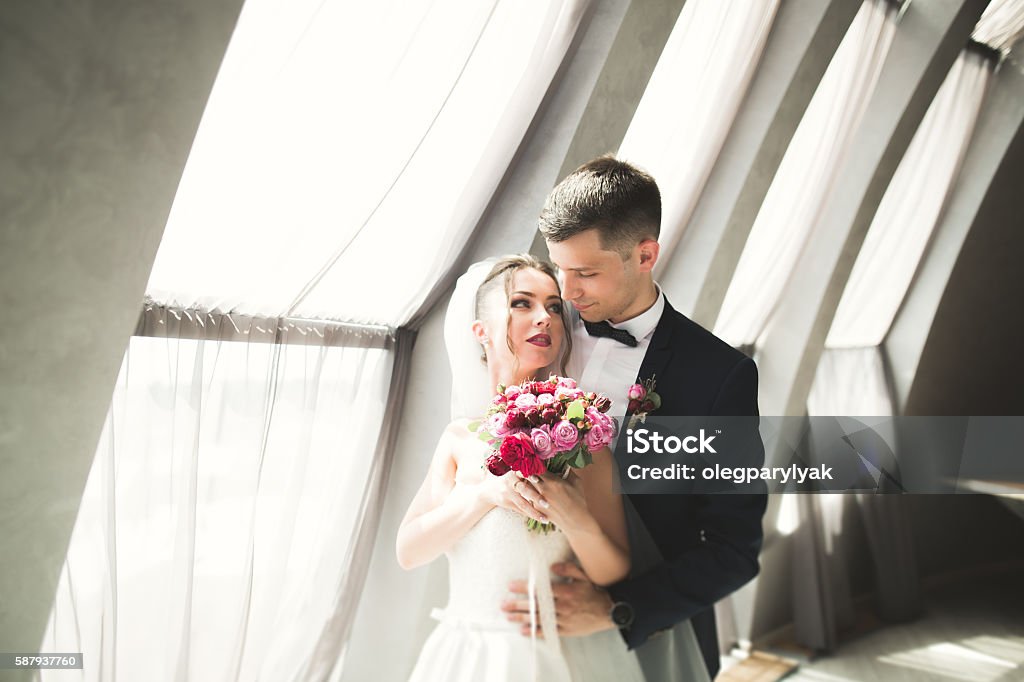 Portrait of happy newly wedding couple with bouquet Portrait of happy newly wedding couple with bouquet. Adult Stock Photo