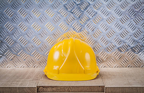 istock Safety hard hat wooden board channeled metal sheet construction 587938632