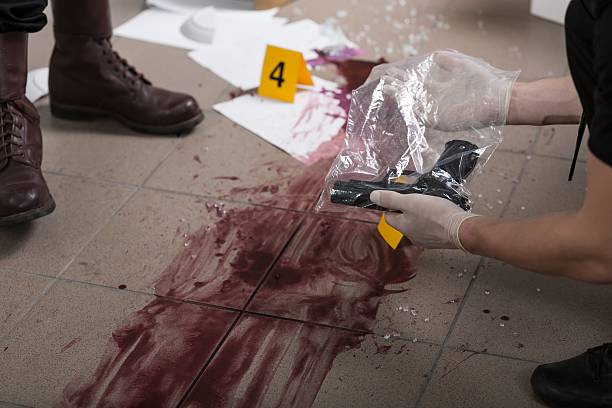 This evidence will lead us to a killer Policeman holding evidence bag with a gun, close up of a bloody splash evidence bag stock pictures, royalty-free photos & images