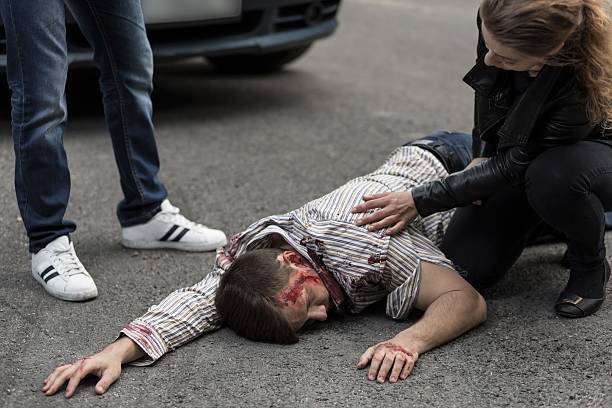 istock People helping injured man 587939368