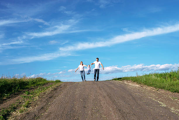 the family walks on the road