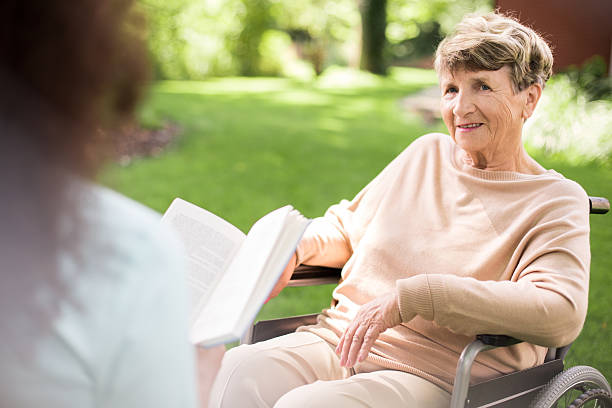 istock Reading to senior woman 587940084