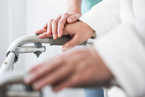 istock Disabled person with walking zimmer 587940180