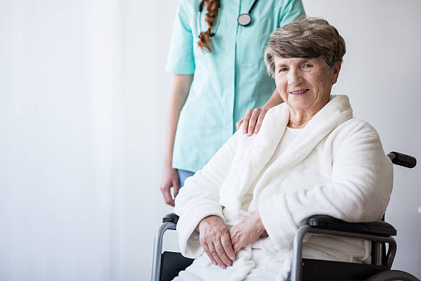 istock Inavlid woman and doctor 587940510