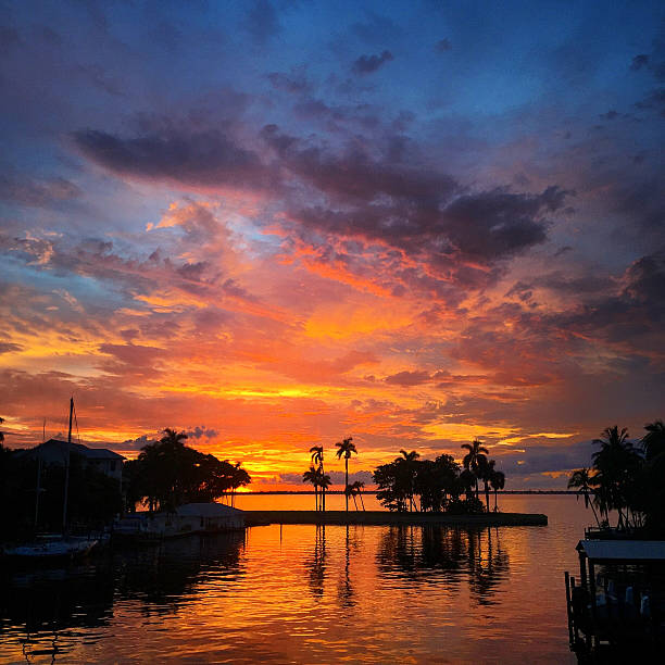 Color stock photo of a beautiful, moody sunset over rippled water in tropical Fort Myers, Florida. Square mobile photo taken with an iPhone 6.
