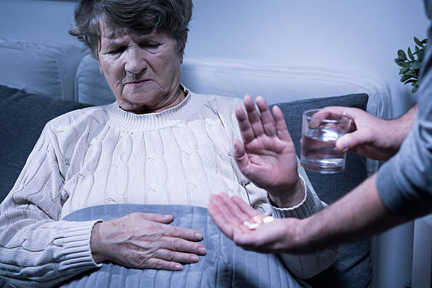 Take it away from me Shot of a senior woman refusing to take her medication refusing photos stock pictures, royalty-free photos & images