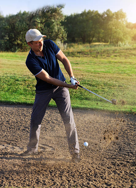 istock Golfer plays a sand trap shot 587942318