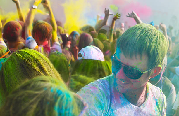 istock Young man on holi color festival 587942670