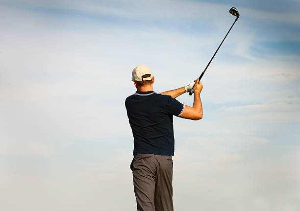 istock Athletic young man playing golf, golfer hitting fairway shot 587943618