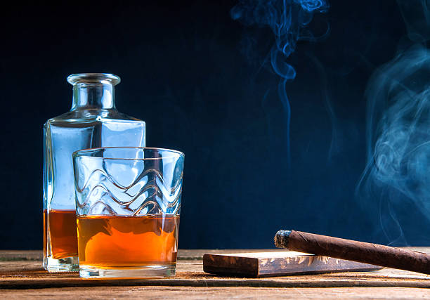 istock Whisky with ice and cigar on wooden table 587943992