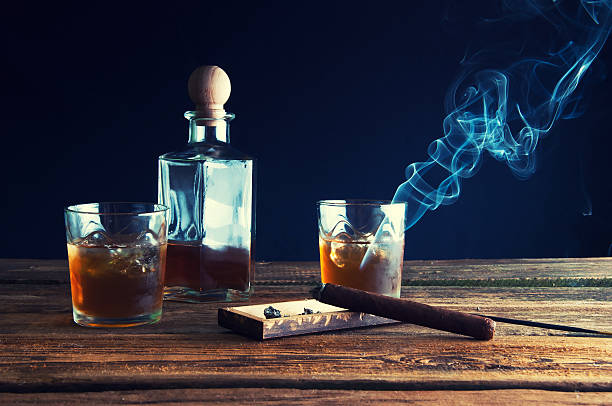istock Whisky with ice and cigar on wooden table 587944494