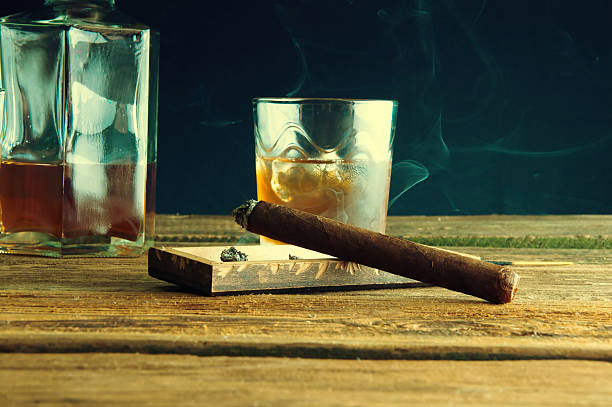 istock Whisky with ice and cigar on wooden table 587944562