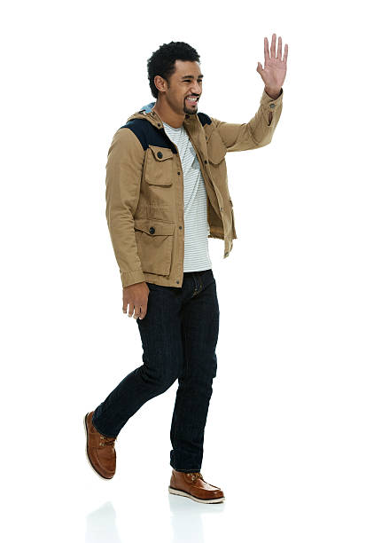 istock Smiling man waving hand and walking 587944718
