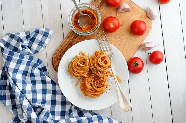 Homemade Spaghetti Pesto Rosso on white plate
