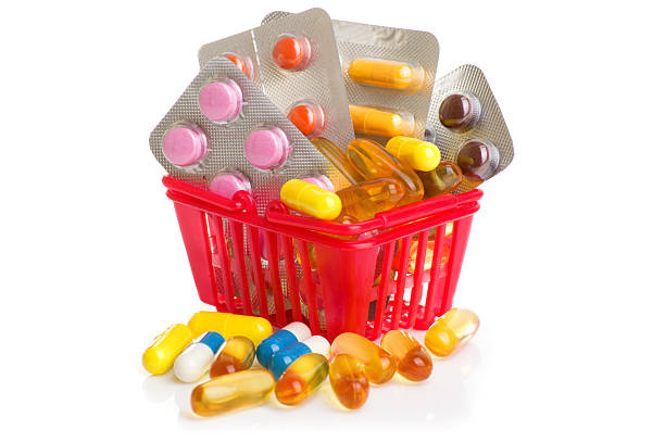 istock Shopping trolley with pills and medicine isolated on white 587947302
