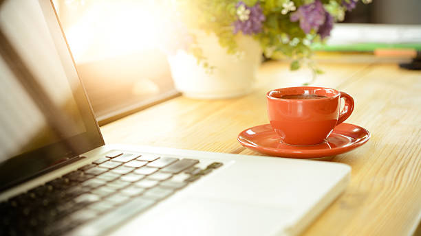 istock coffee cup and laptop on desk in cafe 587948100