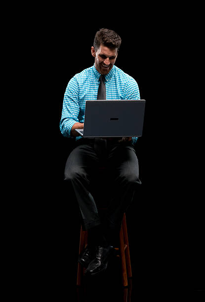 istock Smiling businessman working on laptop 587948732