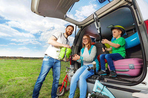istock Young family loading luggage boot for the car trip 587951080