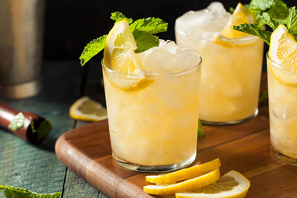 Homemade Boozy Bourbon Whiskey Smash Homemade Boozy Bourbon Whiskey Smash with Lemon and Mint mint julep photos stock pictures, royalty-free photos & images