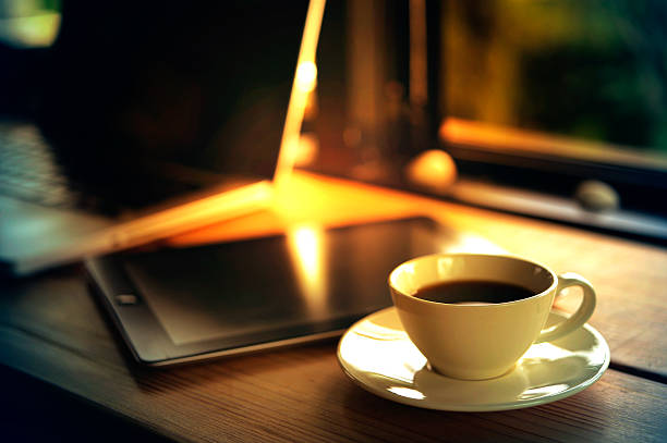 istock Laptop, tablet, smartphone and white cup coffee on wooden table. 587956062